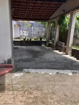 Road facing land with old house for sale