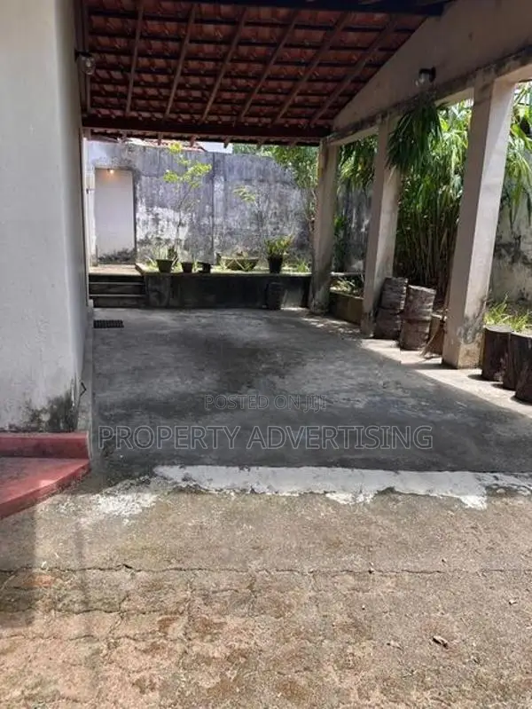 Road facing land with old house for sale