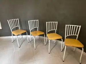 A Steel Table with 4 Cushion Chairs