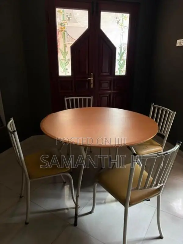 A Steel Table with 4 Cushion Chairs