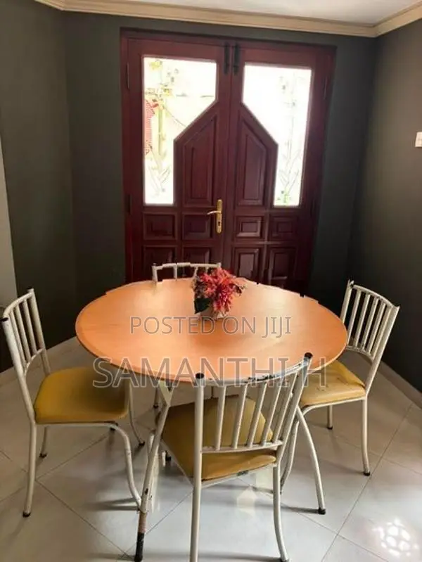 A Steel Table with 4 Cushion Chairs