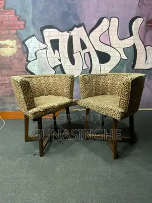 Two wooden chairs with Glass top table