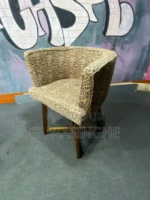 Two wooden chairs with Glass top table