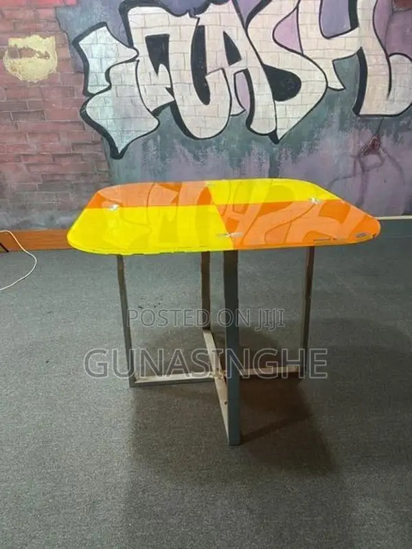 Two wooden chairs with Glass top table