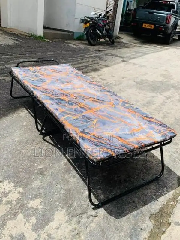 Folding bed with mattress